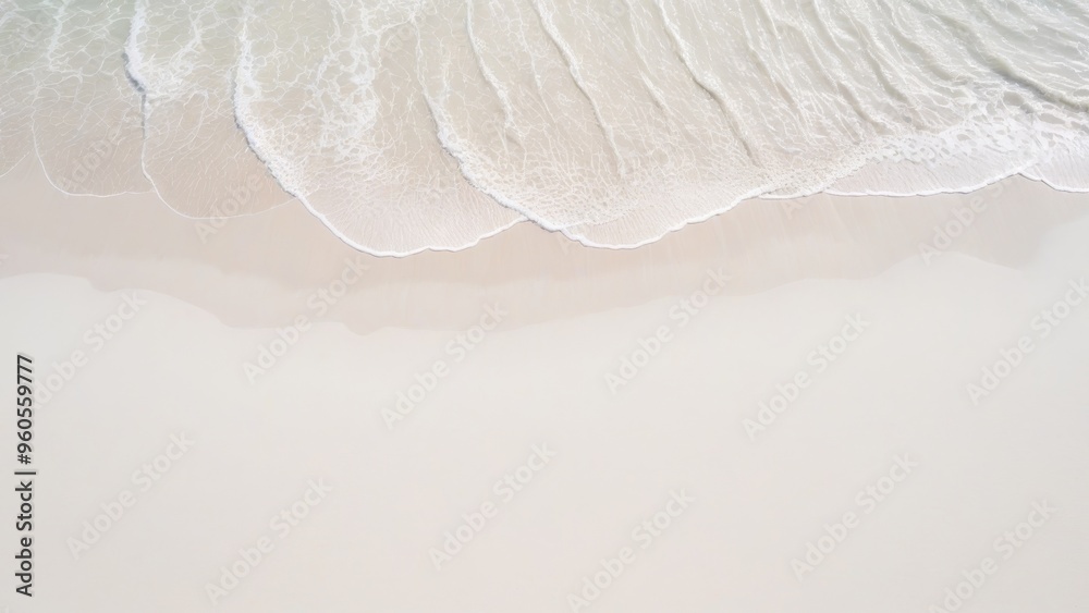 Obraz premium top view of waves on the edge of a white sand beach with texture as a background.