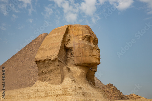 Beautiful profile of the Great Sphinx including pyramids of Menkaure and Khafre in the background on a clear sunny, blue sky day in Giza, Egypt
