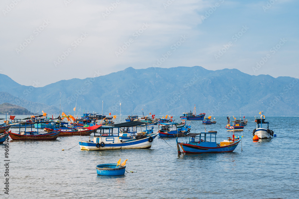 Vietnamese traditional boats at sea at the port in a fishing village near Nha Trang in Vietnam during the summer day Vietnamese traditional boats at sea at the port in a fishing village near Nha Trang in Vietnam during the summer day
