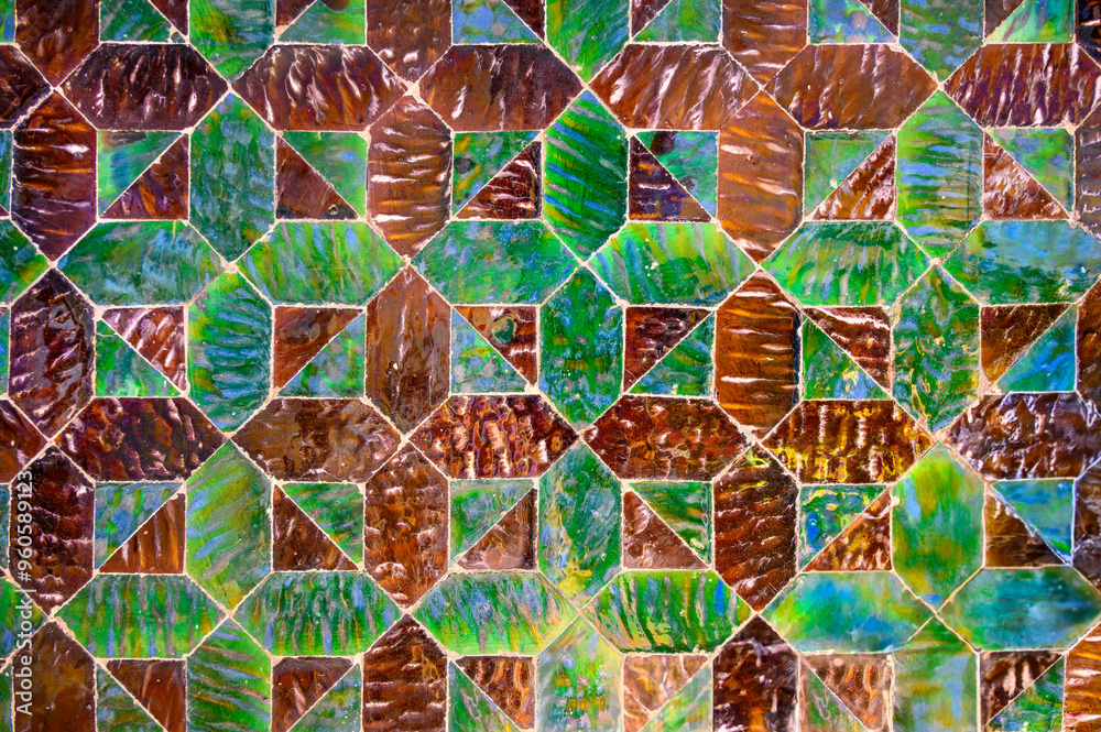 Fototapeta premium Multicolored background of antique glossy tiles of different shapes, arranged in a certain order and pattern
