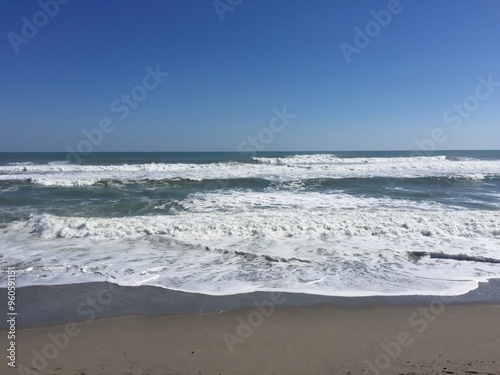 Sunny Florida Beach with Gentle Waves and Clear Blue Sky