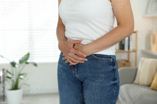 Menopause. Woman suffering from abdominal pain at home, closeup