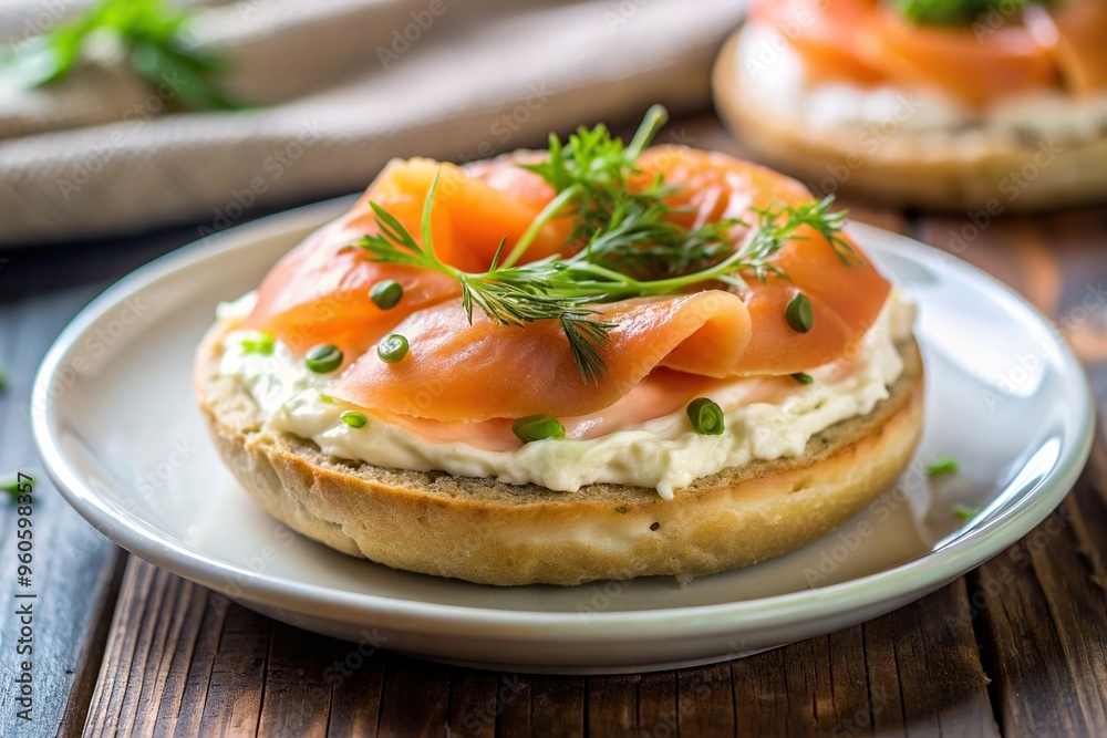 A close up stock photo of a deliciously toasted bagel topped with smoked salmon and cream cheese presented asymmetrically on a plate, savory, asymmetrical, dish, tasty, gourmet A close up stock photo of a deliciously toasted bagel topped with smoked salmon and cream cheese presented asymmetrically on a plate, savory, asymmetrical, dish, tasty, gourmet