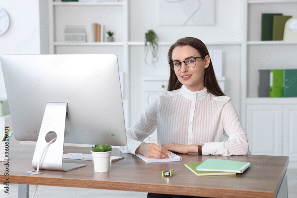 Portrait of smiling businesswoman at table in office Portrait of smiling businesswoman at table in office