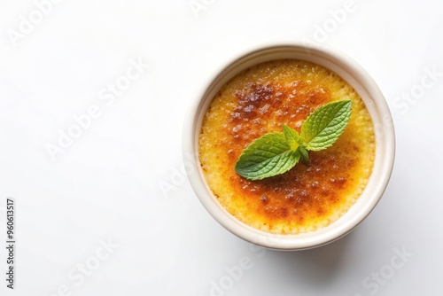 Fragrant Cr?me Br?l?e with Caramelized Sugar and Green Garnish on a White Background Aerial, food, sugar crust, culinary, green garnish, delicious, gourmet, sweet, white background, spoon photo