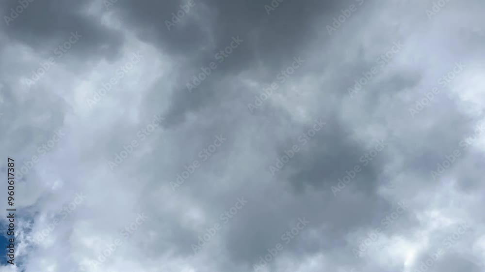 Clouds in the sky on a dark day. Background with white and grey moving clouds, time-lapse. Clouds in the sky on a dark day. Background with white and grey moving clouds, time-lapse.