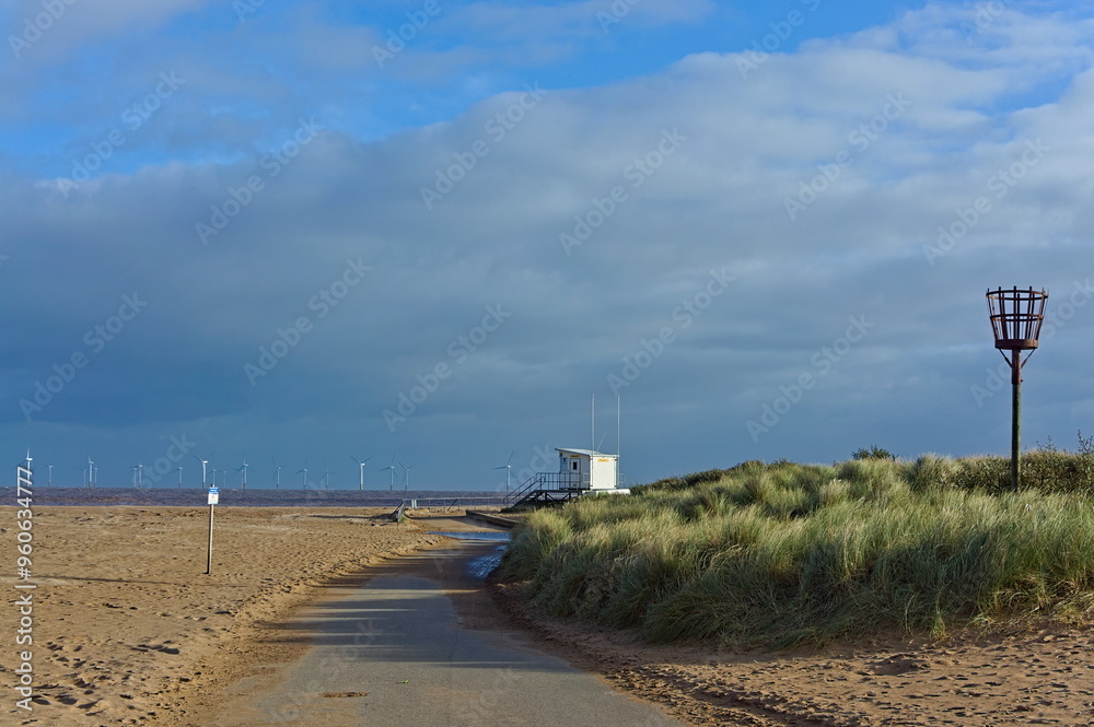 Empty beach during the off-peak season with the lifeguard building in the distance in Skegness UK Empty beach during the off-peak season with the lifeguard building in the distance in Skegness UK