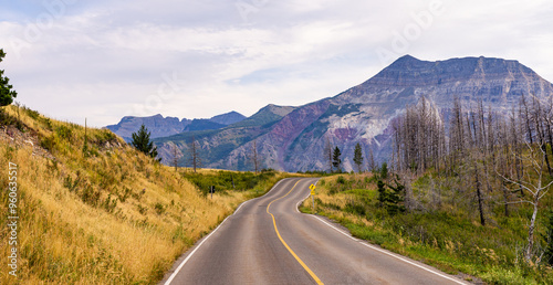 Scenic Road Through Waterton, Alberta with Stunning Mountain Landscape and Open Sky at Sunset