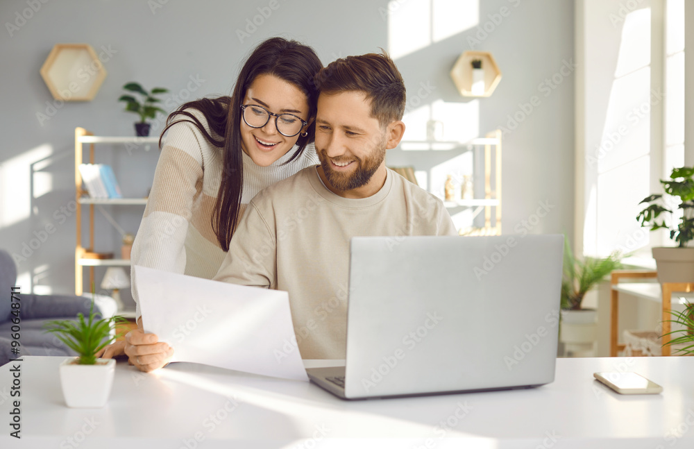 Young couple using laptop, checking financial documents at home. Husband and wife calculating domestic bills, browsing banking services. Happy couple planning budget, discussing and analyzing finances Young couple using laptop, checking financial documents at home. Husband and wife calculating domestic bills, browsing banking services. Happy couple planning budget, discussing and analyzing finances