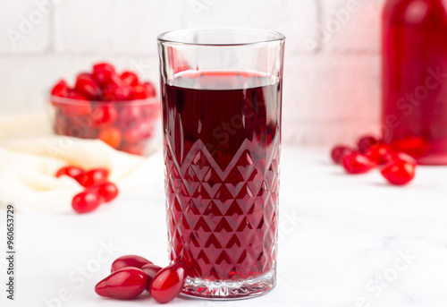 Glass of healthy dogwood berry sherbet drink on light background. Turkish name; Kizilcik serbeti photo