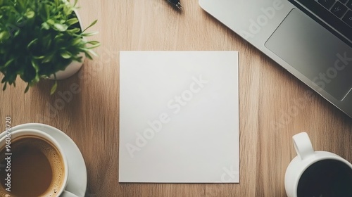 A mockup of an empty white vertical resume document mockup on a wooden office desk with a laptop notebook and pencils above. Typical business curriculum vitae CV and job application.