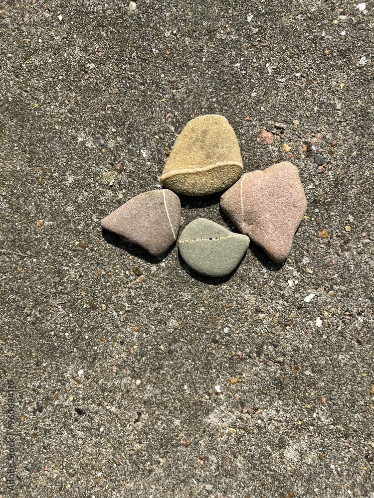 pebbles with a white line lie decorated in a row so that the line is continuous pebbles with a white line lie decorated in a row so that the line is continuous