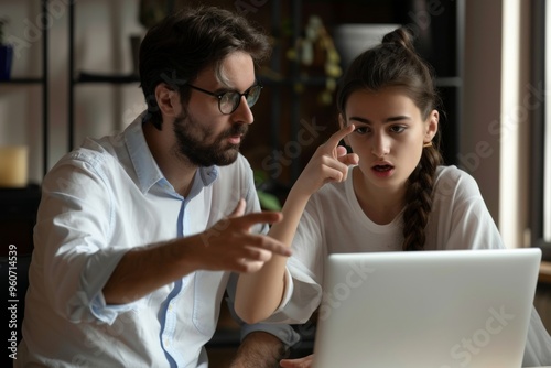 An insightful mentor guides a young student through an online project during a focused meeting in a modern workspace