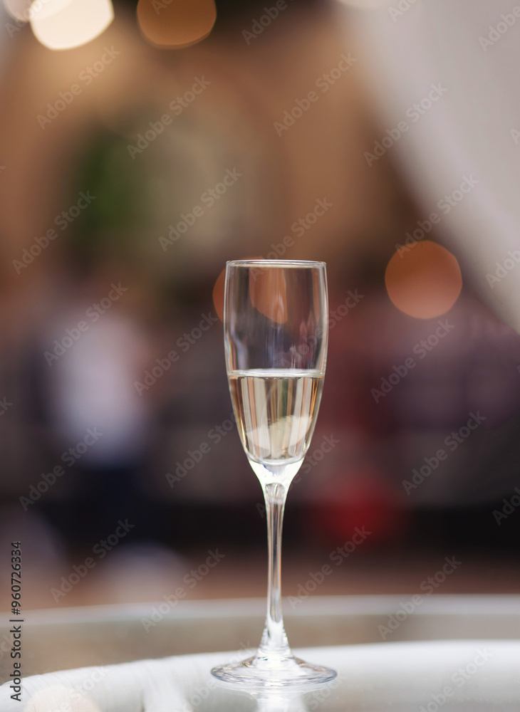 glass of sparkling wine on glass table. glass with prosecco wine in a restaurant. glass of sparkling wine on glass table. glass with prosecco wine in a restaurant.