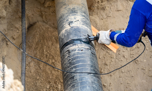 Bild auf Leinwand Trying to cut a gas pipe with an electric branch saw