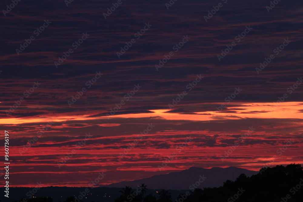 Fototapeta premium A beautiful red sunrise on the shores of the lake