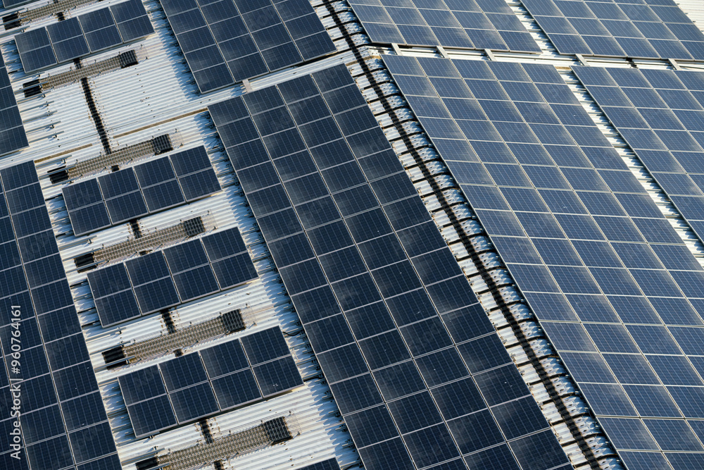 Aerial view of the roof covered with solar panels, at daytime Aerial view of the roof covered with solar panels, at daytime