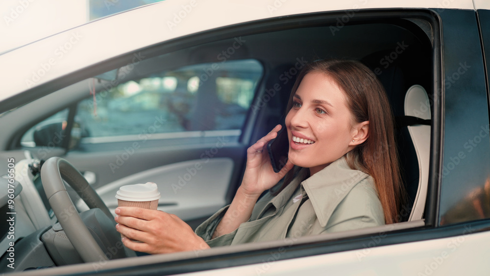 Beautiful young joyful female talking on cellphone and laughing while sitting inside the car and drinking coffee Close up of pretty positive woman calling on smartphone in car and smiling Conversation Beautiful young joyful female talking on cellphone and laughing while sitting inside the car and drinking coffee Close up of pretty positive woman calling on smartphone in car and smiling Conversation