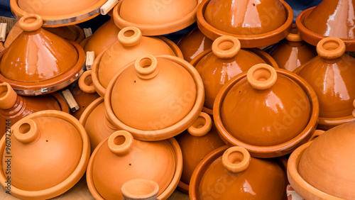 Many traditional ceramic tagine pots on market in Agadir, Morocco. Assortment of glazed and unglazed earthenware tajine pottery