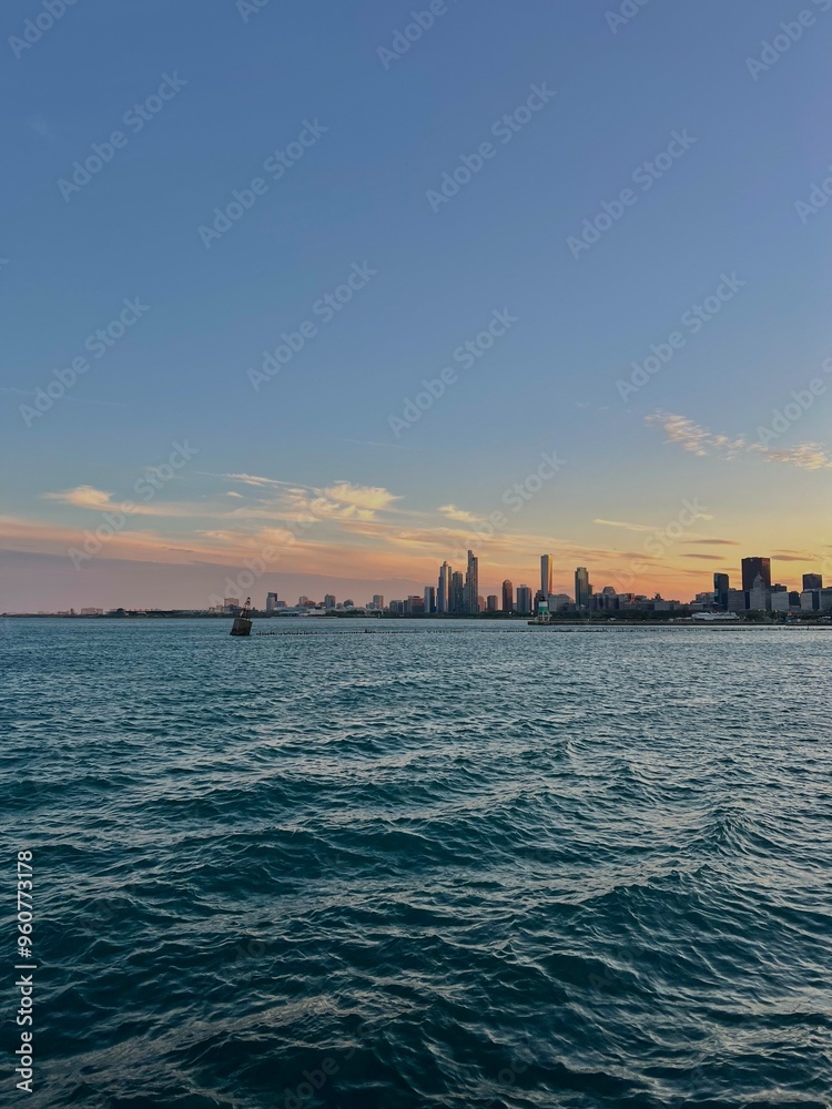 City Skyline By the Port at Sunset with Clear Peachy Skies and Rippled Water City Skyline By the Port at Sunset with Clear Peachy Skies and Rippled Water