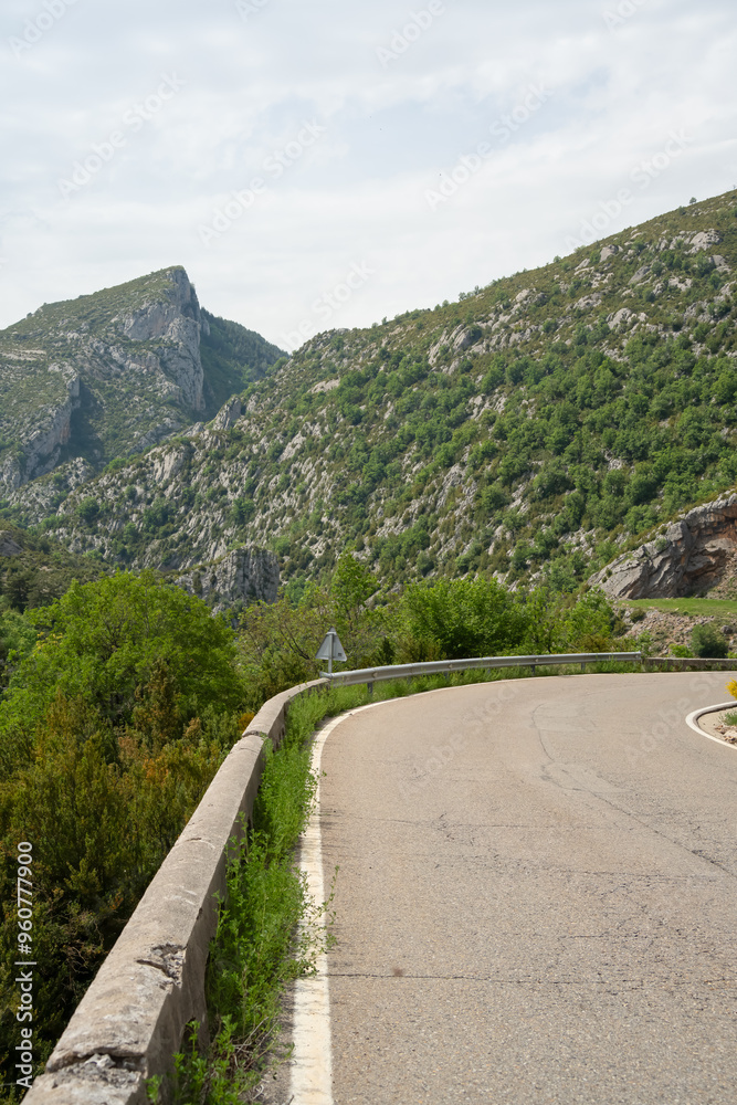 road bends around a corner with mountain gorge backdrop road bends around a corner with mountain gorge backdrop
