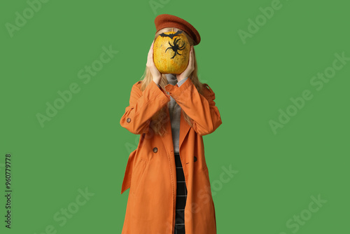 Young woman in orange trenc...
