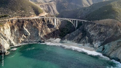Aerial of the rugged coastline of Big Sur California. The Pacific Coast Highway and the famous Bixby Creek Bridge can be seen.