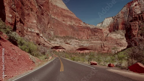 Perfect asphalt road going through a red canyon.