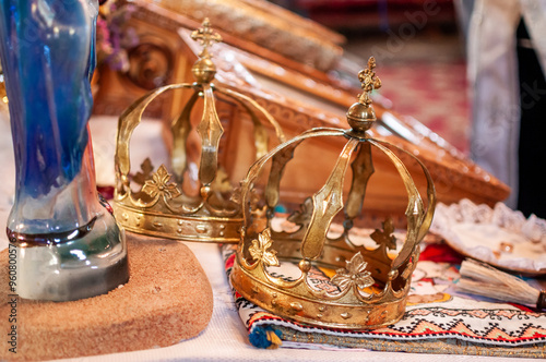 Ornate Golden Crowns on Embroidered Altar Cloth in Church Setting photo