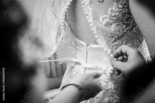 Delicate Moments: Bridal Dress Buttoning in Soft Focus