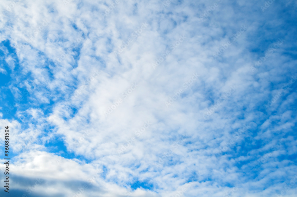 Blue sky background with white dramatic colorful clouds and sunlight. Colorful blue sky landscape, sunny blue sky with picturesque clouds Blue sky background with white dramatic colorful clouds and sunlight. Colorful blue sky landscape, sunny blue sky with picturesque clouds