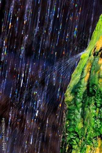 Obraz na plátně Water falling from the natural bridge bounces off of a mossy travertine formation creating a splash of rainbows at Tonto Natural Bridge State Park near Payson, Arizona