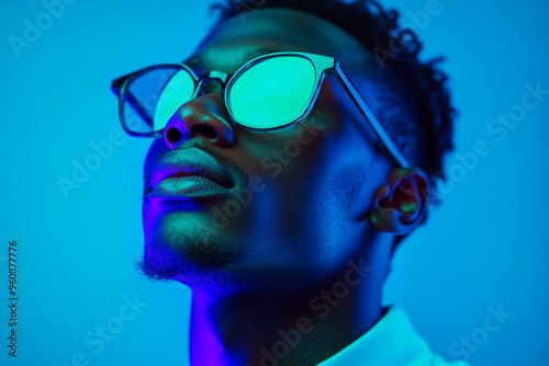 Trendsetting Men in Mountain Green Eyewear with Solid Neon Blue Background Fashion Portrait with Modern Flair