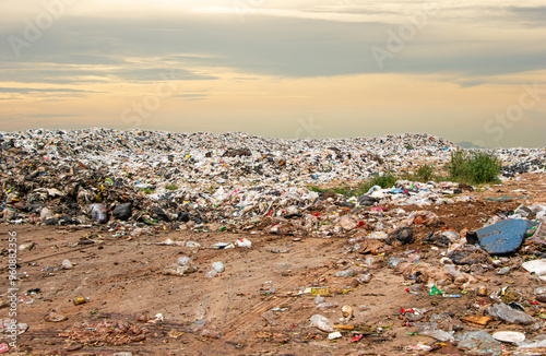 garbage dump pile in trash dump or landfillgarbage dump pile and sunset sky background ,pollution concept
