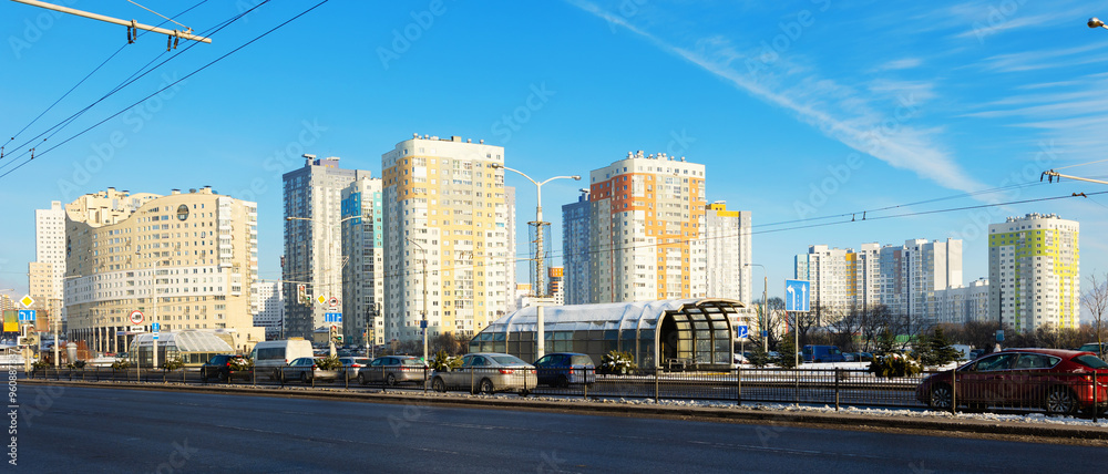 Naklejka premium Modern residential area Malinovka and cars on the wide street in the capital Minsk. Republic of Belarus