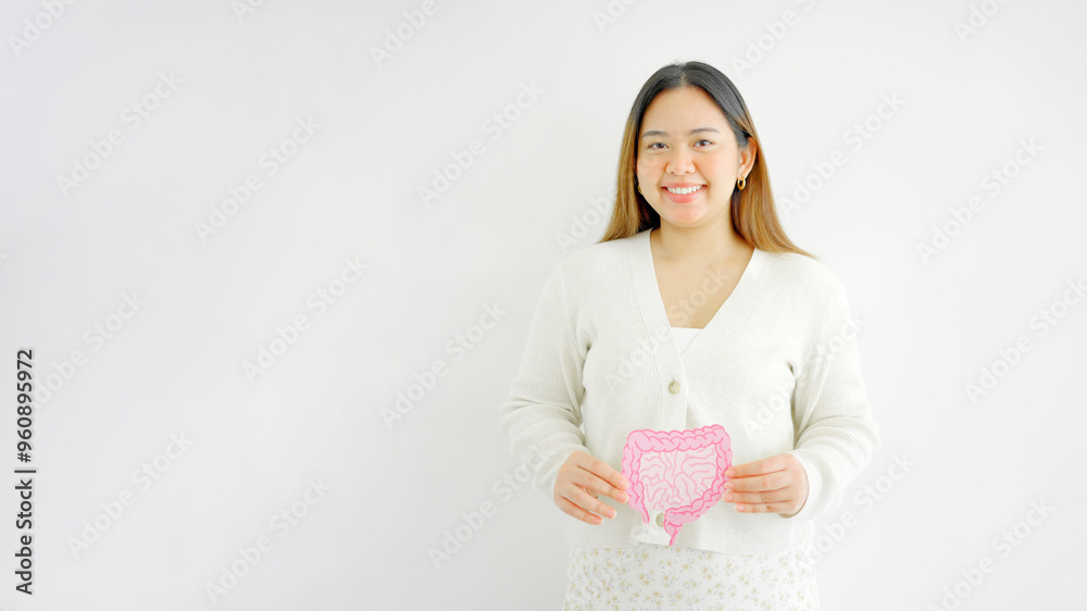 Asian woman hands holding intestine shape, healthy bowel digestion, leaky gut, probiotic and prebiotic for gut health, colon, gastric, stomach cancer concept Asian woman hands holding intestine shape, healthy bowel digestion, leaky gut, probiotic and prebiotic for gut health, colon, gastric, stomach cancer concept