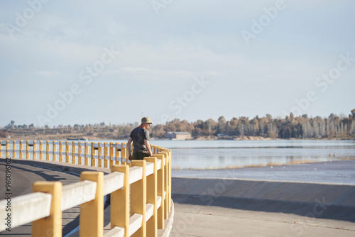 Young man walking along the Carrizal Dam, an important hydroelectric power generation site in Mendoza, Argentina. photo