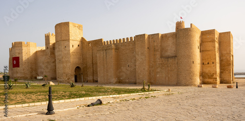 Exterior view of Ribat of Monastir, historical fortress in Tunisia, showcasing sturdy medieval Islamic architecture with high walls and strategic towers .. photo