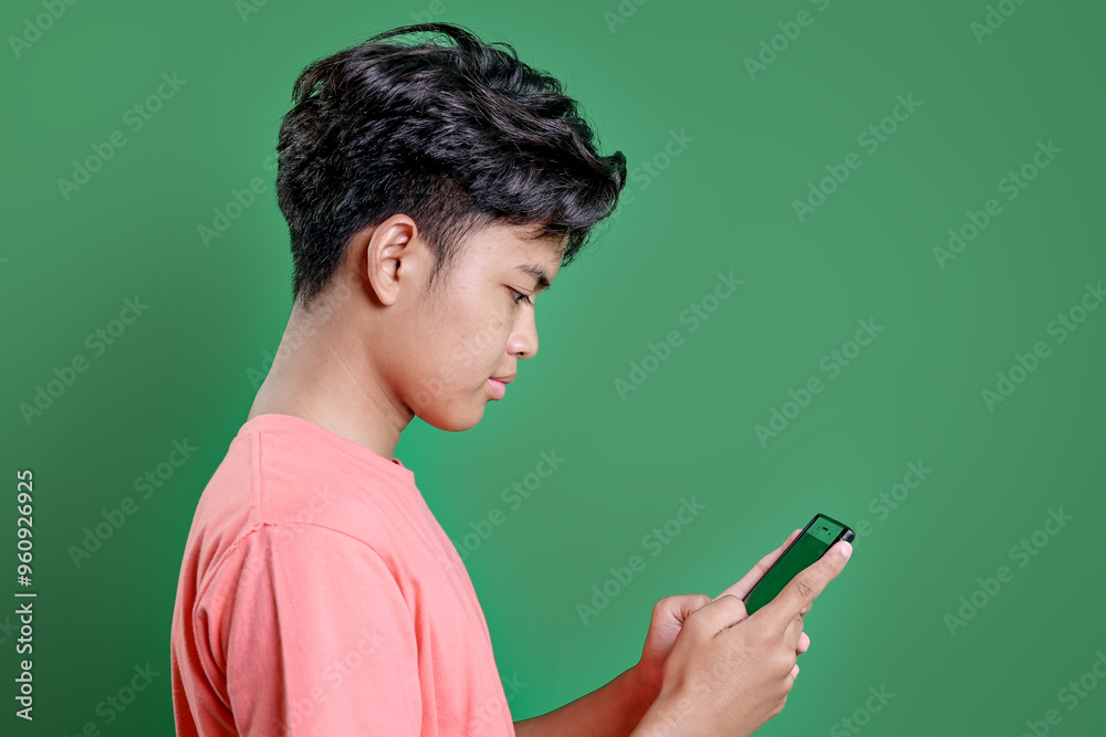 Teenage Boy Playing Games Using Smart Phone Isolated Green Background Teenage Boy Playing Games Using Smart Phone Isolated Green Background