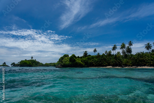 Fototapeta Naklejka Na Ścianę i Meble -  Tropical Island Paradise with Crystal Clear Water, Lush Greenery, and Serene Beaches - Stunning Caribbean Landscape for Eco-Tourism, Adventure, and Unspoiled Nature Travel Destinations