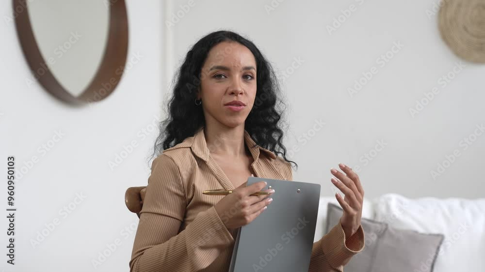 Friendly psychologist woman in clinic office professional portrait with smile and holding clipboard for patient to visit psychologist. The experienced and confident psychologist is crucial specialist Friendly psychologist woman in clinic office professional portrait with smile and holding clipboard for patient to visit psychologist. The experienced and confident psychologist is crucial specialist