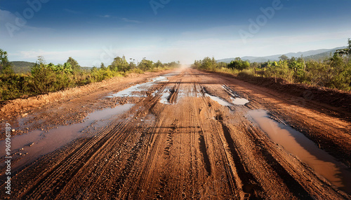 Obraz na płótnie The dirt road is a rural road with dust and potholes. w salonie