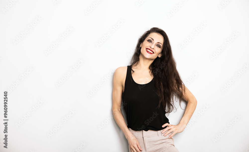 Happy enjoying make-up woman with red lipstick looking happy in black top on white empty copy space background. Portrait Happy enjoying make-up woman with red lipstick looking happy in black top on white empty copy space background. Portrait