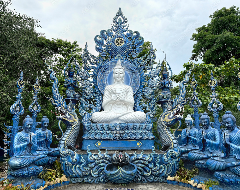 Fototapeta premium The famous Blue temple at Chiang Rai, Thailand, or Wat Rong Suea Ten in Thai. This temple hosts many Buddhist ornaments painted in all blue and gold colors.