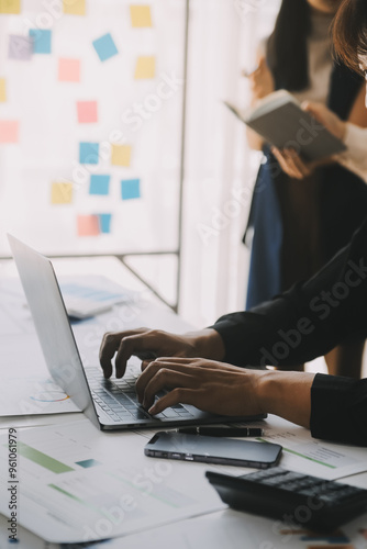 Financial analysts analyze business financial reports on a digital tablet planning investment project during a discussion at a meeting of corporate showing the results of their successful teamwork.