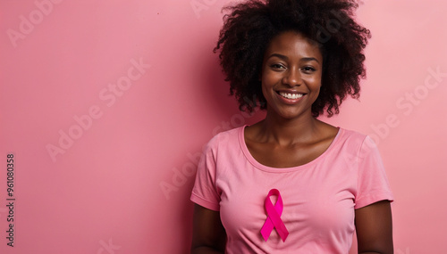 African American woman displays a ribbon for Breast Cancer Awareness Month in October. Our fight photo