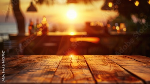 Blurred sunset background with empty wooden table and bar counter.