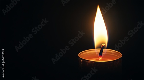 A single candle flame casting a warm glow against a dark background.