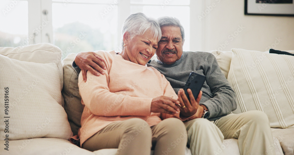 Senior couple, smartphone and happy on sofa with hug, reading and notification with funny story in home. Woman, man and phone in retirement, relax and embrace with comic memory on mobile app in house Senior couple, smartphone and happy on sofa with hug, reading and notification with funny story in home. Woman, man and phone in retirement, relax and embrace with comic memory on mobile app in house