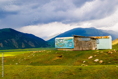 shabby mountain cabin made of old truck bed campers at summer day photo